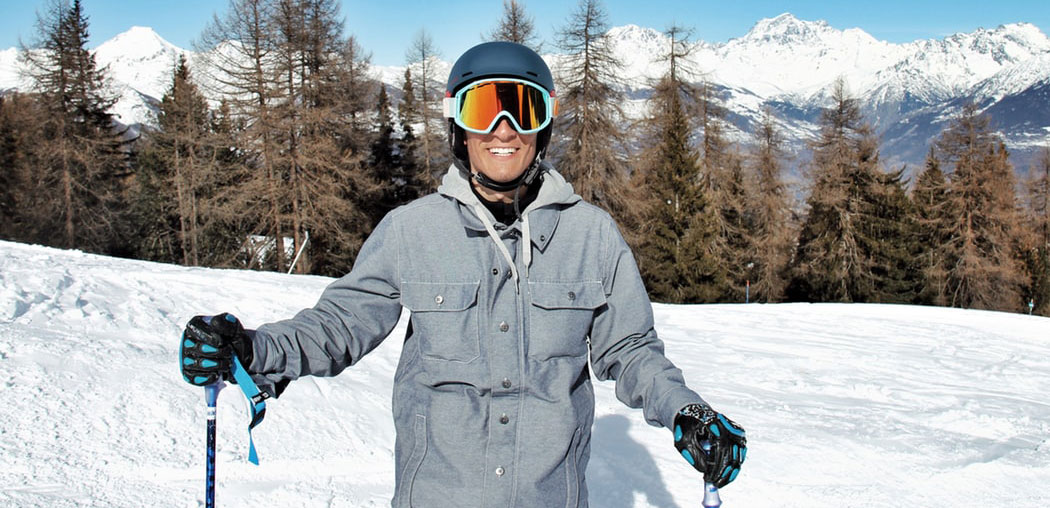 ski outerwear - smiling man wearing ski jacket