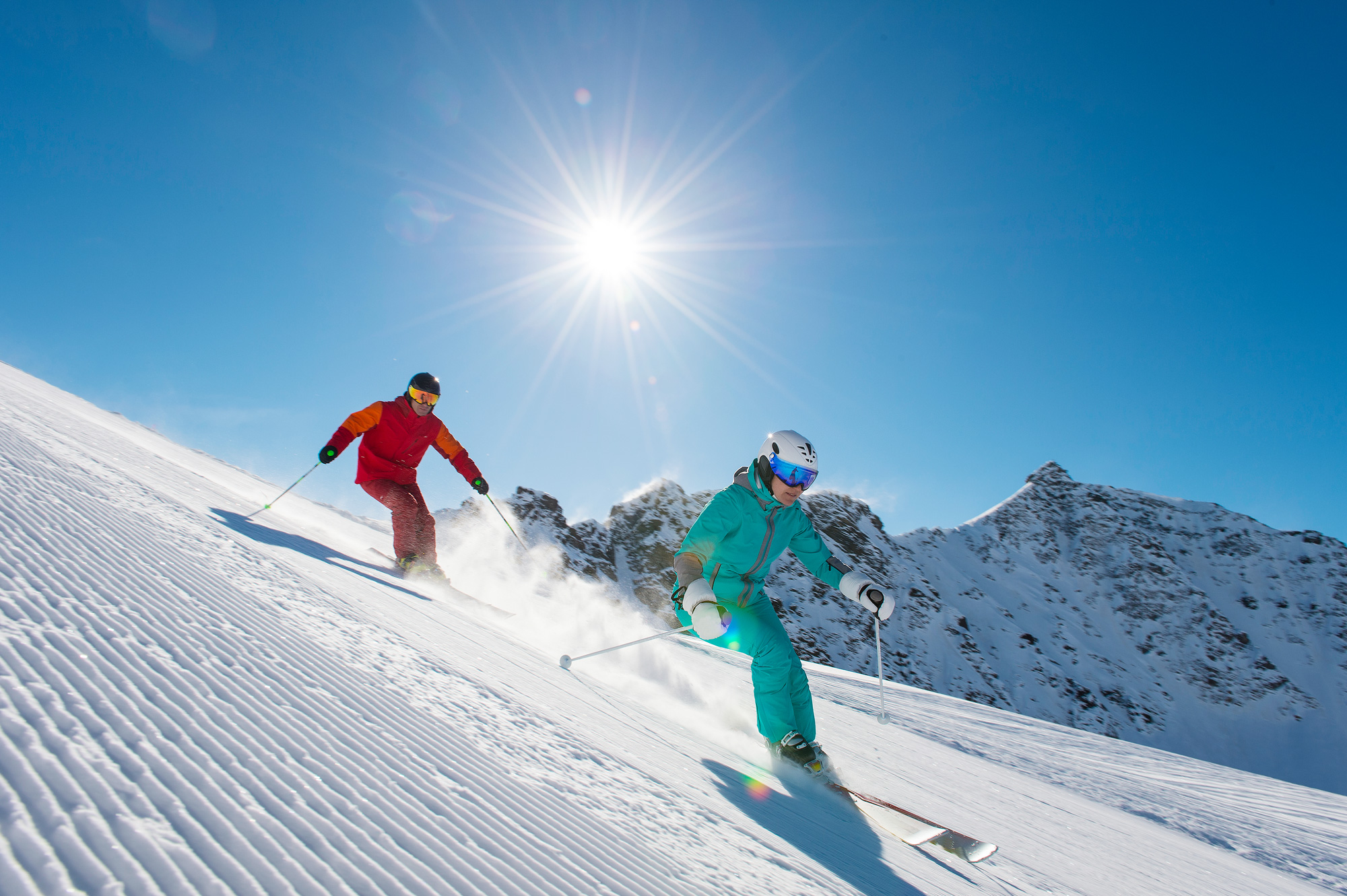 two skiers on sunny piste