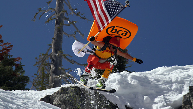 Shane McConkey dressed as Saucer Boy jumps off cliff holding American flag
